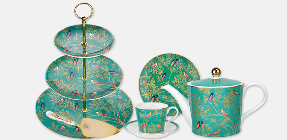 The Chelsea Collection with Green Birds design. Products are a teapot,  teacup and saucer, cake plate, cake slice and cake stand.